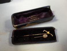 A believed gold (unmarked) fox head & riding crop hat pin & another