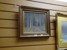 A framed oil painting of woodland, indistinctly signed