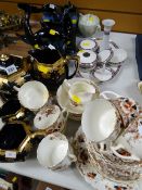 A quantity of mixed teaware, pottery table set, two Poole dolphin ornaments etc