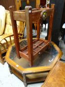 Reproduction octagonal glass topped coffee table with rattan shelf together with a wooden stick /
