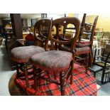 A set of five early twentieth century mahogany balloon backed dining chairs with upholstered seats