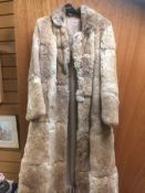 A ginger full length coney fur coat