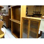 A modern lightwood glass door display cabinet together with a pair of matching mahogany effect