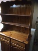 A honey pine kitchen dresser with two-drawer, two-cupboard base & shelf rack