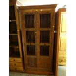 A modern Islamic-style carved decorated two-door cabinet with metal door pulls