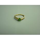 AN EIGHTEEN CARAT GOLD TSAVORITE DRESS RING having an oval faceted solitaire, 5 x 4mms, moderate