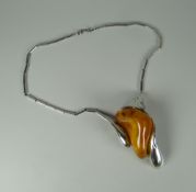 A POLISH SILVER & AMBER PENDANT the silver marked k800 with head profile looking right, on a