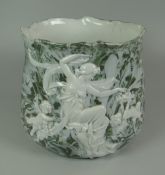 A CONTINENTAL PORCELAIN JARDINIERE with pat-sur-pat style decoration of maiden & cherubs within a