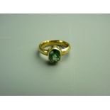 AN EIGHTEEN CARAT GOLD TOURMALINE DRESS RING having an oval faceted solitaire, approximately 9.7 x