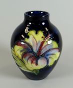 A MOORCROFT SQUAT DEEP BLUE GROUND FLORAL VASE bearing Queen Mary label to base, 9cms high