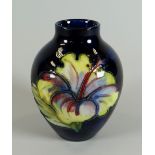 A MOORCROFT SQUAT DEEP BLUE GROUND FLORAL VASE bearing Queen Mary label to base, 9cms high