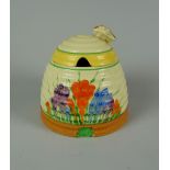 A CLARICE CLIFF POTTERY BEEHIVE HONEY POT with floral decoration & insect handle, 9cms high