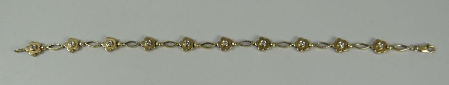 A 14K YELLOW GOLD FLORAL BRACELET with small diamonds, 6.8gms