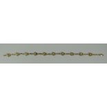 A 14K YELLOW GOLD FLORAL BRACELET with small diamonds, 6.8gms