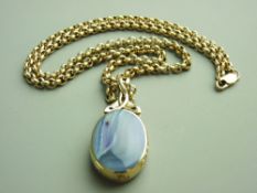 A NINE CARAT GOLD AGATE & BLUE GOLDSTONE OVAL PENDANT in an attractive mount and having a 60cms