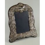 A MODERN REPRODUCTION SILVER EASEL PORTRAIT FRAME with raised Victorian style decoration, Birmingham