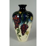 A 2009 MOORCROFT BALUSTER VASE in the Grapevine pattern, 16cms high