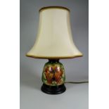 A MODERN MOORCROFT LIMITED EDITION (5/198) TABLE LAMP in the Fireflower pattern by Rachel Bishop