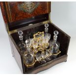 A NAPOLEON III PERIOD WALNUT MARQUETRY LIQUOR CABINET having a folded hinged lid & flanking