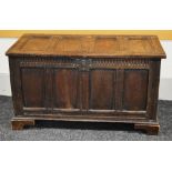 A LATE EIGHTEENTH CENTURY OAK BLANKET CHEST having a four panel facade and four panel hinged lid