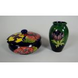 A MOORCROFT BLUE GROUND DISH & COVER (A/F) together with a miniature Moorcroft baluster vase