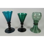 A NINETEENTH CENTURY GERMAN ETCHED GREEN GLASS HOCK on a swirl form spreading foot and two near-