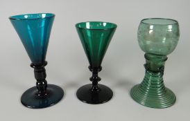 A NINETEENTH CENTURY GERMAN ETCHED GREEN GLASS HOCK on a swirl form spreading foot and two near-