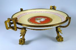 A CONTINENTAL PORCELAIN COMPORT on a gilt metal stand, the interior of the porcelain decorated