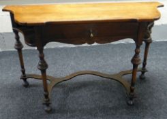 A SHAPED MAHOGANY SIDE TABLE with single drawer, raised above turned & tapering four corner supports