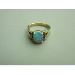 AN EIGHTEEN CARAT GOLD OPAL DRESS RING having an oval cabochon opal of approximately 9 x 7mms,