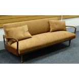 A 1950s GREAVES & THOMAS TEAK DAYBED / SETTEE with open sides & shaped arms raised over turned