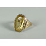 A VICTORIAN GOLD & CITRINE RING the stone in a relief decorated border and with engraved