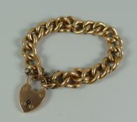 A 9ct YELLOW GOLD HOLLOW LINK BRACELET & HEART SHAPED PADLOCK, 24.1gms