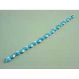 AN EIGHTEEN CARAT WHITE GOLD DIAMOND SET TURQUOISE COLOURED HEART LINK BRACELET of twenty dyed