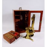 AN ANTIQUE BRASS BINOCULAR MICROSCOPE BY J H STEWARD with two rise & fall adjusters, two adjusters