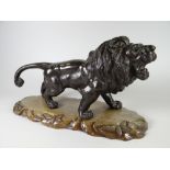 A HEAVY QUALITY METALLIC PROWLING LION MODEL having Chinese character mark to the underside & on a
