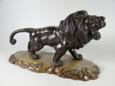 A HEAVY QUALITY METALLIC PROWLING LION MODEL having Chinese character mark to the underside & on a