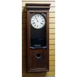 A BUNDY TIME RECORDER CLOCKING-ON MACHINE in an oak case with Bundy insignia to the facade, the