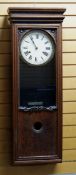 A BUNDY TIME RECORDER CLOCKING-ON MACHINE in an oak case with Bundy insignia to the facade, the