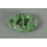 A CHINESE CARVED SPINACH JADE TOGGLE in the form of two fighting lions in opposition, 4cms long