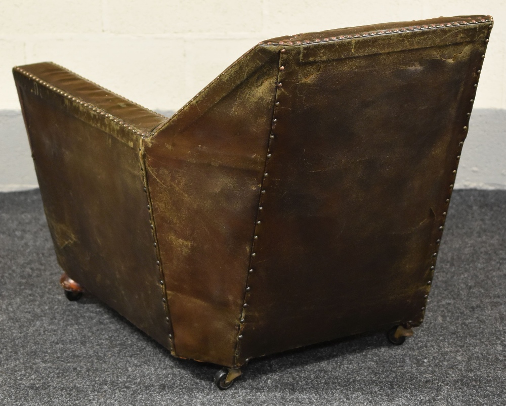 AN UNUSUAL STUDDED LEATHER ANTIQUE ARMCHAIR on bun feet with castors - Image 2 of 4