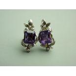 A PAIR OF FOURTEEN CARAT WHITE GOLD AMETHYST & DIAMOND STUD EARRINGS, each having an emerald faceted