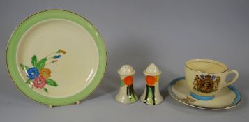 A CLARICE CLIFF SALT & PEPPER SET decorated with fruit, together with a Clarice Cliff tea plate &