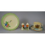 A CLARICE CLIFF SALT & PEPPER SET decorated with fruit, together with a Clarice Cliff tea plate &