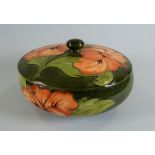 A MOORCROFT GREEN GROUND TUBE-LINED FLORAL DISH & COVER with raised knop, 17cms diam