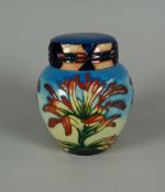 A YEAR 2000 MOORCROFT LIDDED GINGER JAR in the Indian Paintbrush pattern, 11cms high