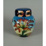 A YEAR 2000 MOORCROFT LIDDED GINGER JAR in the Indian Paintbrush pattern, 11cms high