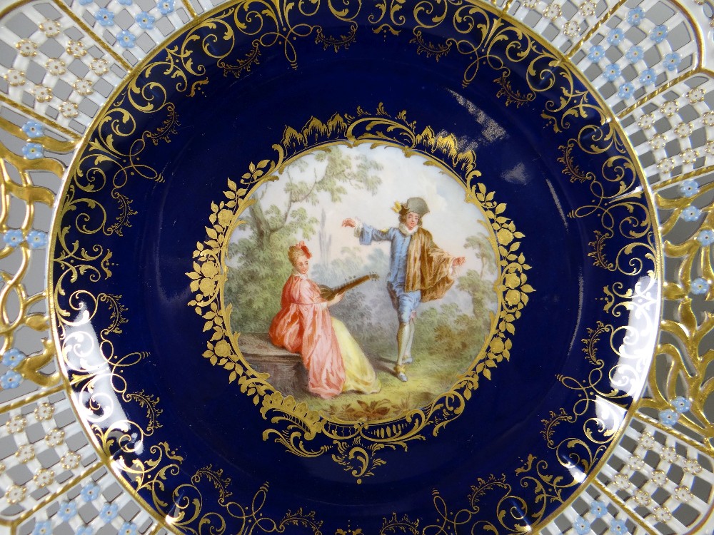 A PAIR OF MEISSEN RIBBON PLATES centred with a hand decorated Watteau-style vignette of courtiers in - Image 2 of 4
