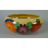 A CLARICE CLIFF SHALLOW FRUIT BOWL IN THE 'GAY DAY' PATTERN decorated with flowers, 20cms diam