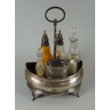 A GEORGE III SILVER CRUET STAND being mahogany lined and of gondola form raised over four feet and